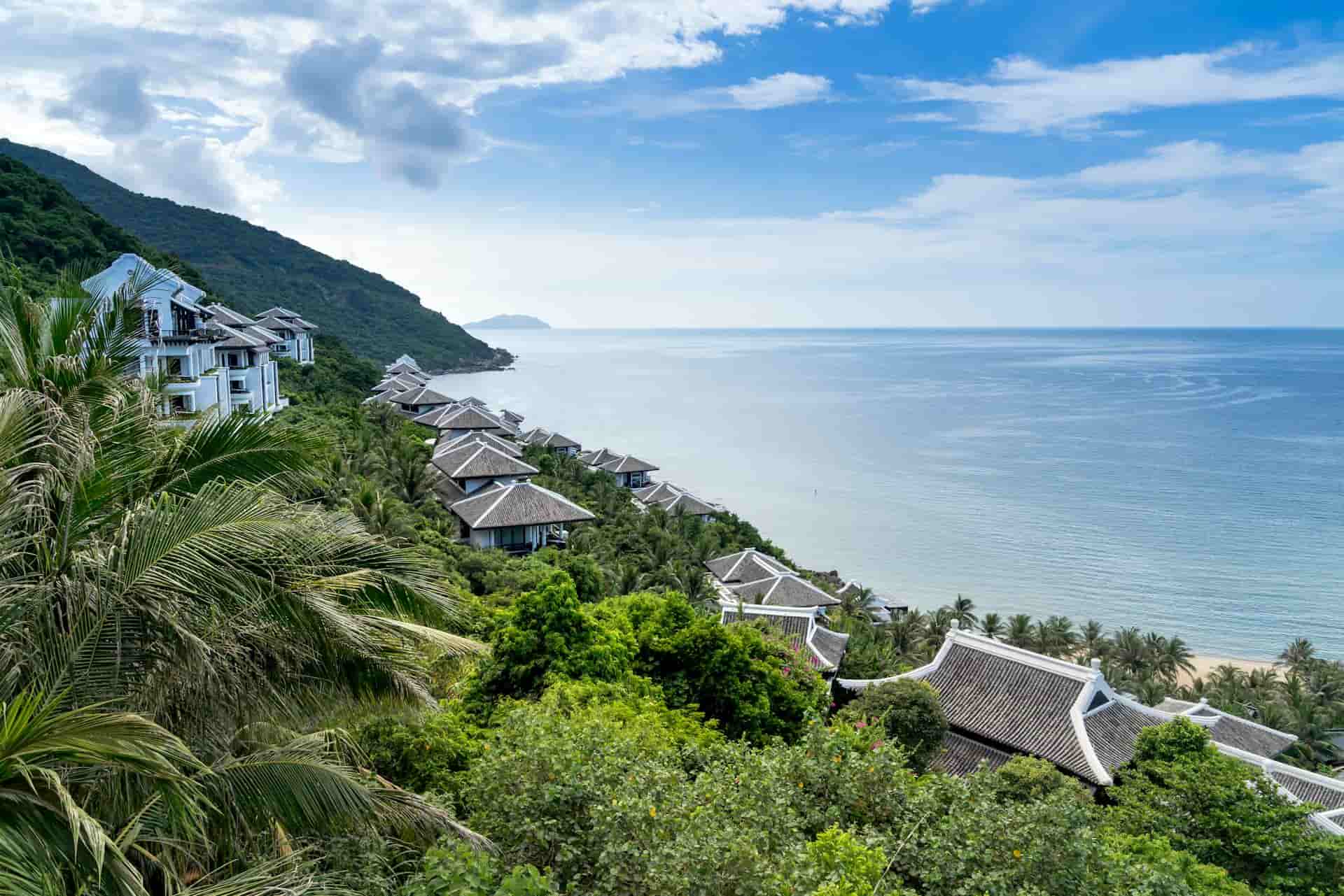 Beautiful tropical beach with resort villas and lush greenery in Asia.