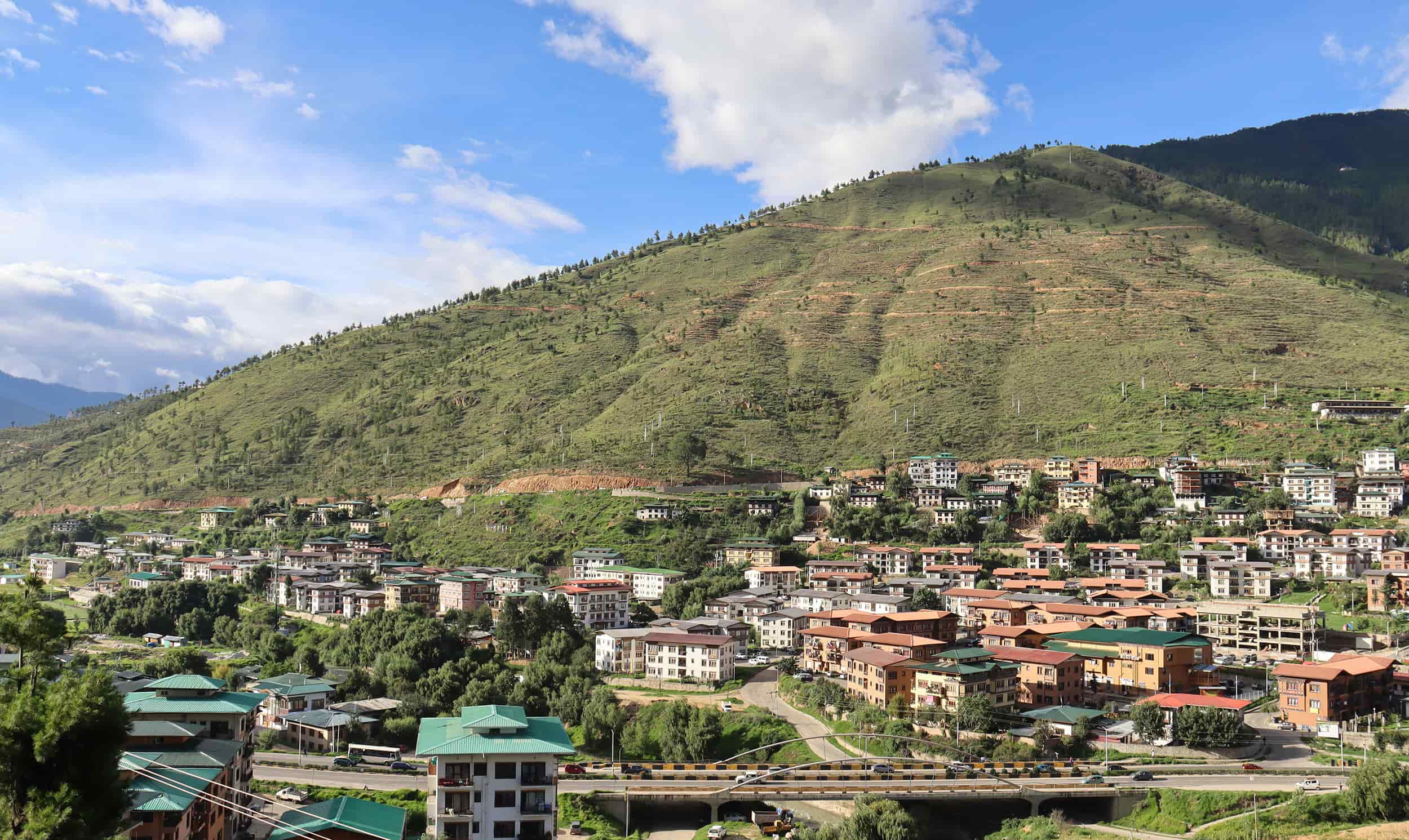 Scenic mountain village with colorful houses and lush greenery, perfect for travel and adventure in.